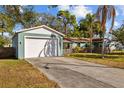Detached two-car garage and driveway of single Gathering home with fenced-in area on a sunny day at 3235 34Th N Ave, St Petersburg, FL 33713