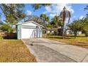 Detached two-car garage and driveway with fenced-in area of single Gathering home on a sunny day at 3235 34Th N Ave, St Petersburg, FL 33713