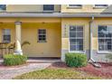 Close-up of townhouse exterior featuring a covered entryway and decorative stone accents at 3870 Island Way, St Petersburg, FL 33705