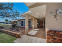 Welcoming front porch with tiled flooring, brick accents, and stylish landscaping at 4191 39Th S St, St Petersburg, FL 33711