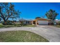 Inviting home with a wide driveway and lush front lawn, complemented by mature trees and landscaping at 4191 39Th S St, St Petersburg, FL 33711