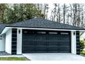 Close up of a modern-looking garage door with windows along the top and contemporary trim at 4222 Autumn Leaves Dr, Tampa, FL 33624