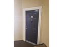 Front door of unit 101, with a dark finish and a secure peephole at 5125 Palm Springs Blvd # 1101, Tampa, FL 33647