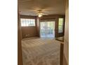 Living room featuring neutral carpet, ceiling fan, and sliding glass doors to balcony at 5125 Palm Springs Blvd # 1101, Tampa, FL 33647