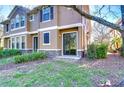 Charming exterior view of a home with a sliding glass door and landscaped backyard at 5704 Kingletsound Pl, Lithia, FL 33547