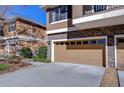 Exterior of a townhome showcasing the garage and stone accents at 5704 Kingletsound Pl, Lithia, FL 33547