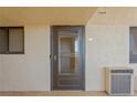 Condo exterior featuring unit 307's door, window, and a/c unit at 6009 Sea Ranch Dr # 307, Hudson, FL 34667