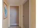 Hallway with the unit's front door and a doorway to another room at 6009 Sea Ranch Dr # 307, Hudson, FL 34667