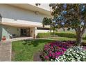 Beautifully landscaped entrance to the building, featuring flowers, a bench, and a manicured lawn at 6279 Sun Blvd # 605, St Petersburg, FL 33715