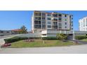 Low exterior shot of a multi-story condo building, showcasing balconies and well-maintained landscaping at 6279 Sun Blvd # 605, St Petersburg, FL 33715