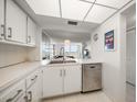 Bright white kitchen featuring stainless steel appliances, tile floors, and modern lighting at 6279 Sun Blvd # 605, St Petersburg, FL 33715