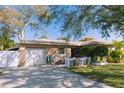 Welcoming single-Gathering home featuring an attached garage, quaint courtyard, and beautiful greenery at 6315 25Th N Ave, St Petersburg, FL 33710