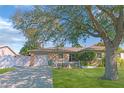 Inviting one-story residence featuring a brick facade, a garage, and a lush green lawn at 6315 25Th N Ave, St Petersburg, FL 33710