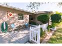 Cozy front porch featuring a charming seating area and a quaint garden with a white picket fence at 6315 25Th N Ave, St Petersburg, FL 33710