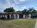 A beautiful single-story home with solar panels, a large yard, and mature trees at 8630 Winter Haven Dr, Hudson, FL 34667