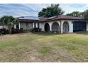 Well-maintained one-story home with solar panels and arched entry into a screened porch at 8630 Winter Haven Dr, Hudson, FL 34667