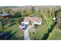 Expansive property featuring a well-manicured lawn, multiple vehicles on a paved drive, and outbuildings at 8946 Old Pasco Rd, Wesley Chapel, FL 33544