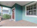View of front porch showing the hardscape flooring and light blue exterior at 10639 Carloway Hills Dr, Wimauma, FL 33598