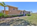 Well-maintained home exterior with manicured lawn and decorative bushes at 1154 Jameson Greens N Dr # 20, Sun City Center, FL 33573