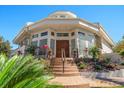 Front exterior featuring a grand entrance with a unique window design and professionally landscaped garden at 118 Waterberry Dr, Tarpon Springs, FL 34688