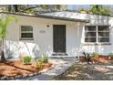 Close-up of front entrance with brick walk way and well-kept landscaped at 1212 E Crawford St, Tampa, FL 33604