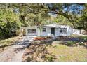 Attractive single-story home with a covered front entry, complemented by mature trees at 1212 E Crawford St, Tampa, FL 33604