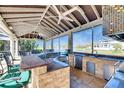 Outdoor kitchen with a built-in bar, sink, stainless steel mini-fridge, and views of the water at 1335 Jumana Loop, Apollo Beach, FL 33572