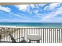 Condo balcony view of the beach and ocean with outdoor seating at Sea Breeze of Madeira at 13500 Gulf Blvd # 505, Madeira Beach, FL 33708