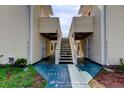 Condo building exterior with well-maintained stairs and walkways for easy access at 136 Sycamore Ln # C, Oldsmar, FL 34677