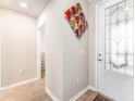 Bright entryway with decorative wall art, a decorative glass door, and access to other rooms at 13915 Kingfisher Glen Dr, Lithia, FL 33547