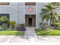 Close-up of building entrance featuring well maintained landscaping and clear signage at 1610 Raena Dr # 107, Odessa, FL 33556