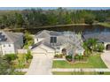 Aerial view of the home, showcasing the backyard water view and solar panels at 20330 Natures Corner Dr, Tampa, FL 33647