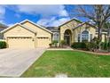 Charming single-story home featuring a well-manicured lawn and a three-car garage at 20330 Natures Corner Dr, Tampa, FL 33647