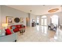 Spacious living room featuring tile flooring, high ceilings, and elegant furnishings at 20330 Natures Corner Dr, Tampa, FL 33647