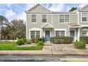Exterior shot of townhomes with neat front yard landscaping at 2352 Lake Woodberry Cir, Brandon, FL 33510