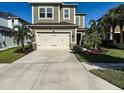 Charming two-story home with a well-manicured lawn, features a two-car garage and elegant landscaping at 29011 Trevi Pl, Wesley Chapel, FL 33543