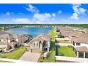 Gorgeous aerial view of the house, showcasing a scenic lake and well-maintained lawns at 3027 Marine Grass Dr, Wimauma, FL 33598