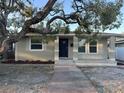 This inviting single-story home features a brick facade and front door with sidelights at 3711 1St S Ave, St Petersburg, FL 33711