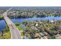 Panoramic aerial view of the property with a river and bridge nearby at 3820 E Lakeshore Dr, Tampa, FL 33604