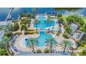 Aerial view of a resort-style community pool with palm trees, a slide, and ample seating at 410 Manns Harbor Dr, Apollo Beach, FL 33572
