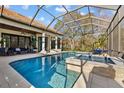 Relax in this beautiful screened-in pool and spa with an outdoor seating area, perfect for entertainment at 5204 Avenue La Crosse, Lutz, FL 33558