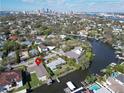 Aerial view of waterfront property and neighborhood, with a city skyline in the distance at 547 Suwanee Cir, Tampa, FL 33606