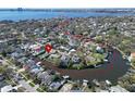 Aerial view of waterfront property in a residential neighborhood near open bay at 547 Suwanee Cir, Tampa, FL 33606