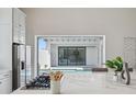 Elegant kitchen featuring a pass-through window offering stunning pool views, blending indoor and outdoor living seamlessly at 5932 Red Mangrove Ln, Bradenton, FL 34210