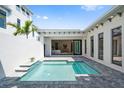 Outdoor oasis featuring a private pool with a view into the main bedroom with an open and connected indoor-outdoor living space at 5932 Red Mangrove Ln, Bradenton, FL 34210
