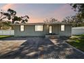 Charming single-story home featuring a brick facade, a well-manicured lawn, and a welcoming front entrance at 8025 N Gomez Ave, Tampa, FL 33614