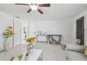 Bright living room boasts white tile, sunflower decor, and neutral furniture, creating a modern ambiance at 8025 N Gomez Ave, Tampa, FL 33614
