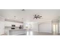 Open-concept kitchen featuring stainless steel appliances and a large center island at 10800 Tarflower Dr # 202, Venice, FL 34293