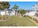 Charming single-story home with well-maintained lawn, palm trees, and a cozy front porch at 13429 Lisa Dr, Hudson, FL 34667