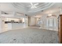 Open-concept living room with elegant tray ceilings and great natural light at 13941 Talmage Loop, Hudson, FL 34667